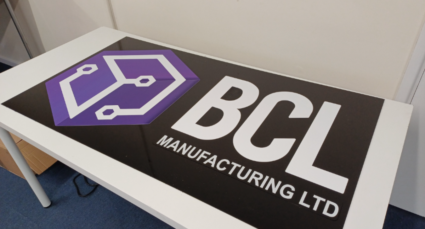 Large gloss black plastic business sign with custom printed lettering for shopfront or commercial use